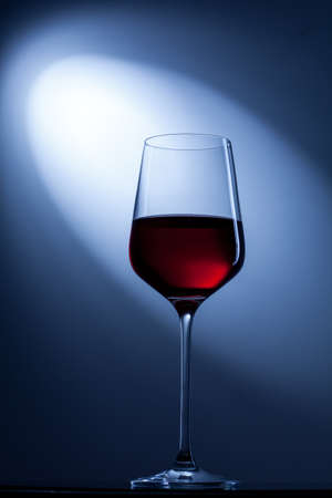 red wine in glass on blueの写真素材
