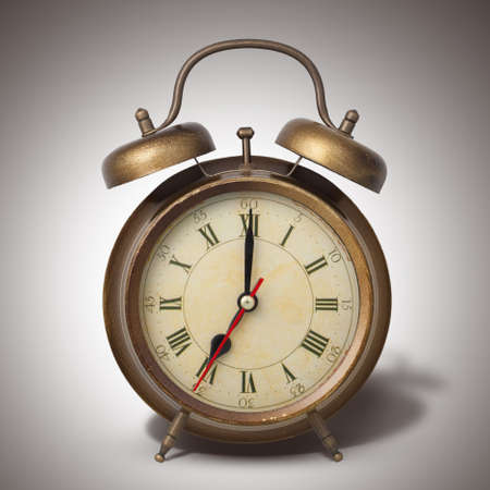 Brown old style alarm clock with shadow