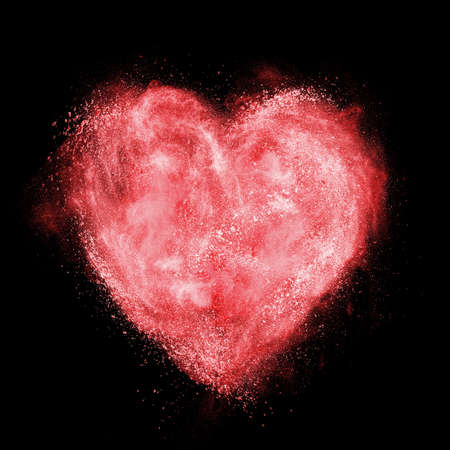 red heart made of white powder explosion isolated on black backgroundの写真素材