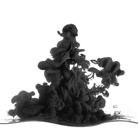 Splash of black ink in dropped into the water isolated on whiteの写真素材