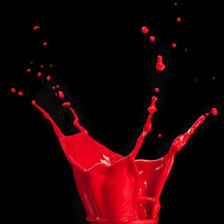 splash of red paint isolated on black background