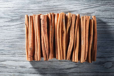 Cinnamon sticks isolated on white wooden tableの写真素材
