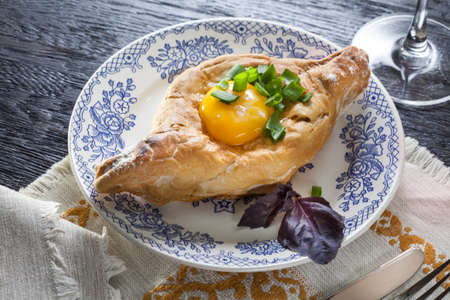 Khachapuri on plate with herbs