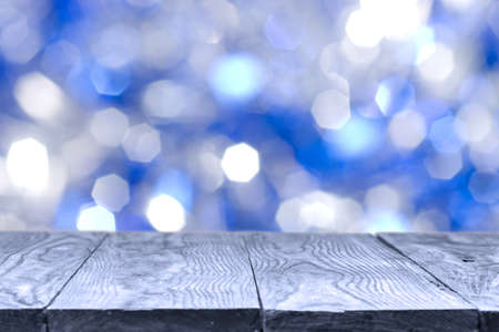 wooden table and blue bokeh abstract natural holidays on backgroundの写真素材