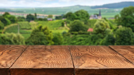 Empty wooden table with vineyard landscape in France on background. Header for websiteの写真素材
