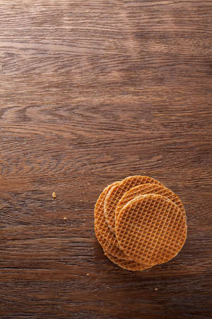 Waffles with caramel on wooden background. Top viewの写真素材
