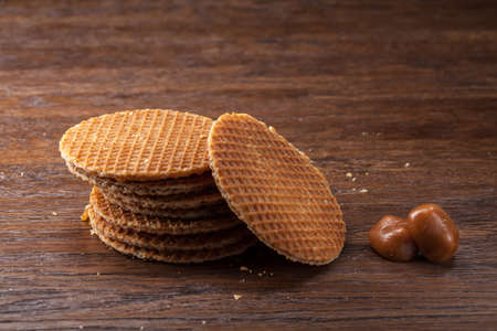 Waffles with caramel on wooden background. Top viewの写真素材