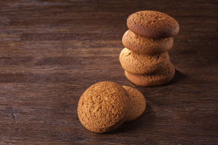 pile of oat cookies on wooden table