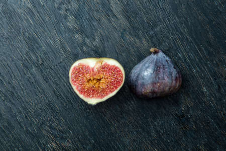 Fresh figs isolated on black wood background