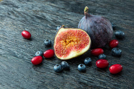 Fresh organic figs, dogwood, blueberries and plumsの写真素材