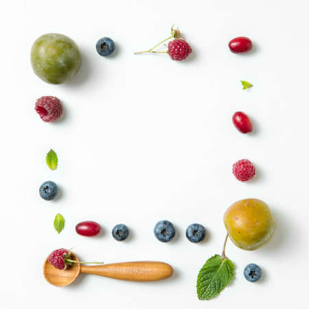 frame with berries on isolated white backgroundの写真素材