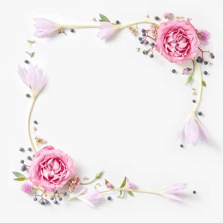Fresh pink roses frame border isolated and copyspace for text on white backgroundの写真素材