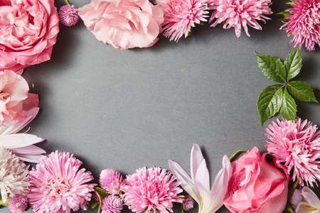 Beautiful pink flowers frame on black backgroundの写真素材