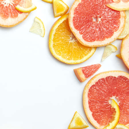 Close up of fresh citrus lemon, orange, grapefruit slices on white backgroundの写真素材