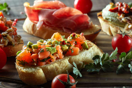 Bruschetta set . Black wood background, top view, horizontal compositionの写真素材