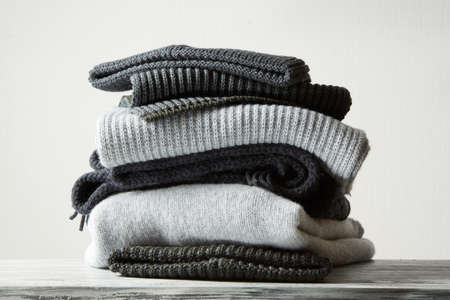 Pile of knitted winter clothes on background, sweaters, knitwear,の写真素材