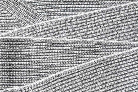 Closeup macro texture of knitted cotton fabric, clothing background with folds