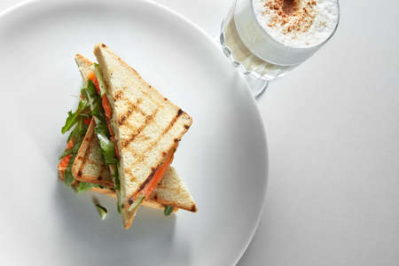 English breakfast with cup of coffee with toasts at the white backgroundの写真素材