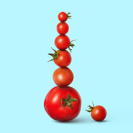 fresh cherry tomatoes isolated on a blue background, healthy lifestyleの写真素材