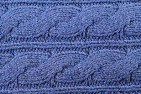 Blue knitted texture with ornament braids as background