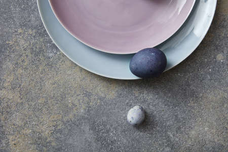 Blue easter eggs with plates on stone backgroundの写真素材