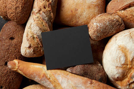 Different kinds of bread on background