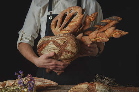 Variety of bread hold mens hands