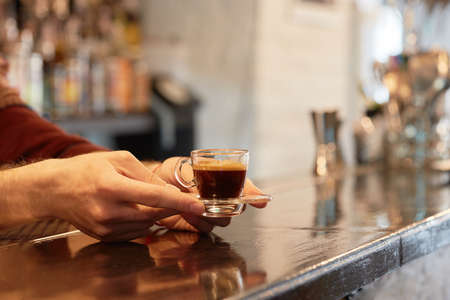 Female hand holding cup of coffeeの写真素材