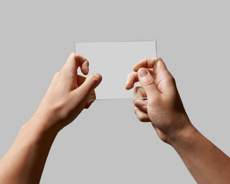 transparent glass in male handsの写真素材