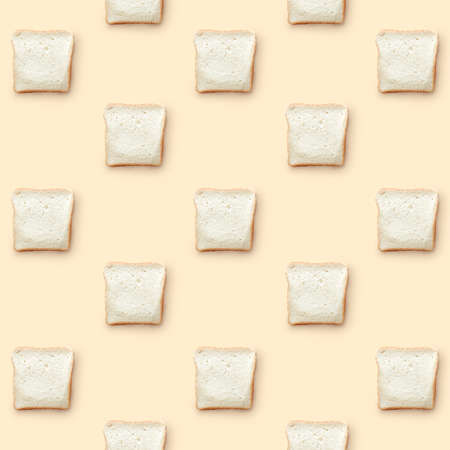 pattern from pieces of white bread on a beige background flat layの写真素材