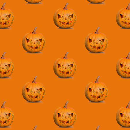 pattern of halloween pumpkins on an orange backgroundの写真素材