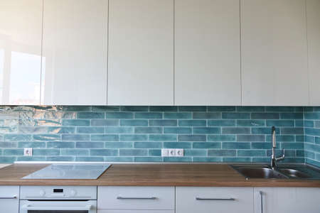 Brown countertop in the kitchen, sink, blue tile, interior backgroundの写真素材