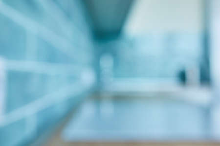 Natural lens bokeh.blurred texture of blue ceramic tiles and kitchen countertop with hob. Can be used as a backgroundの写真素材