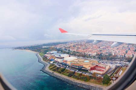 beautiful view from the airplane window to the city and the sea. aerial viewの写真素材
