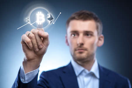 the man clicks Icon Bitcoin on virtual screen.