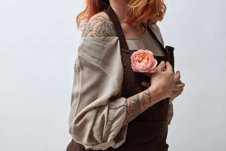 Girl with a pink flower in her handの写真素材