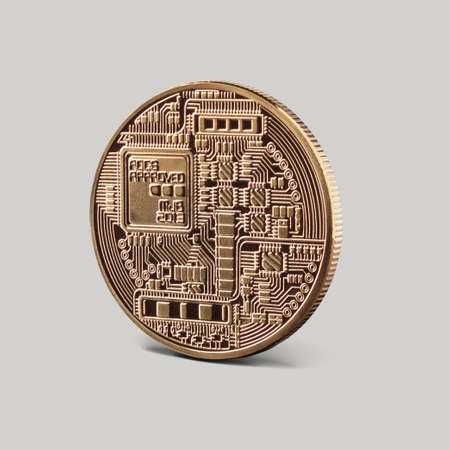 Back side of the coin bitcoin gold on a gray background. New Virtual money concept. Cryptocurrency. Business concept.の写真素材