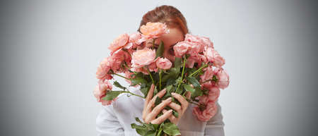 Bouquet of beautiful roses in the hands of a girl