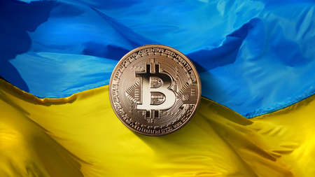 bitcoin Gold on a Ukrainian flag background. State regulation of the crypto currency market. Ukraine is one of the five fastest growing countries in the world in the crypto currency market. Cryptocurrency and blockchain trading concept. Can be used for video or site coveの写真素材