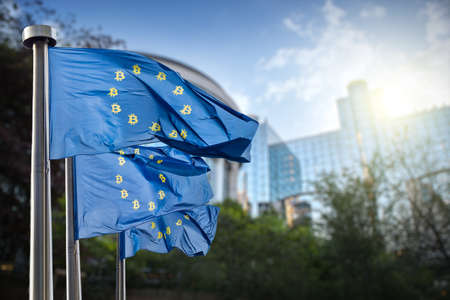 On the blue flag the symbol bitcoin. Regulation of crypto currency bitcoin by the European Union. Cryptocurrency and blockchain conceptの写真素材