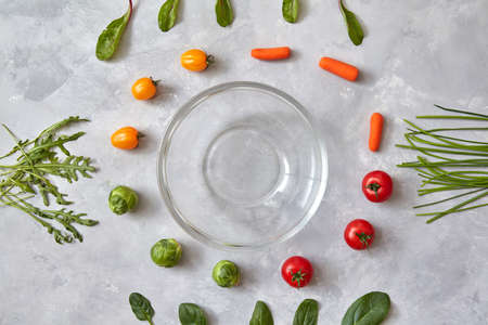 Varied vegetables and herbs and empty glasses, a photo of a step-by-step recipe for salad cooking. Top view, flat layの写真素材