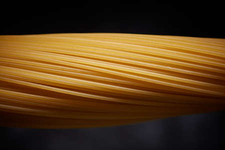 Close-up of raw spaghetti on a black backgroundの写真素材