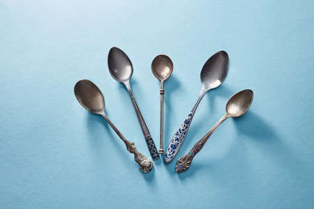 Tea spoons are in a blue background, top view