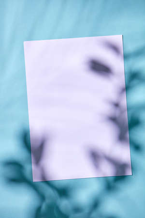 Cardboard with a pattern of shadows on a blue background with a copy space. Flat lay.
