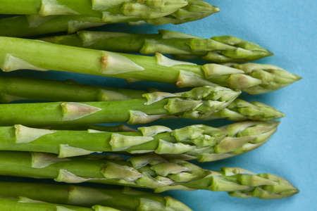 Fresh green asparagus for cooking on blue backgroundの写真素材