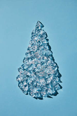 Ice cubes in the form of a drop on a blue background. Flat layの写真素材