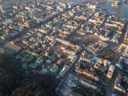 The panoramic birds eye view from drone to the central historical part of the city Kiev - the Podol district, the Dnieper River in Kiev, Ukraine at summer sunset.の素材 [FY310103849568]