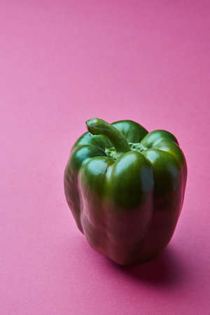 Fresh green paprika isolated on pink backgroundの写真素材