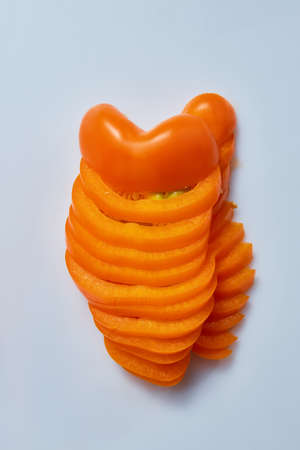 Half of chopped yellow pepper on a gray backgroundの写真素材