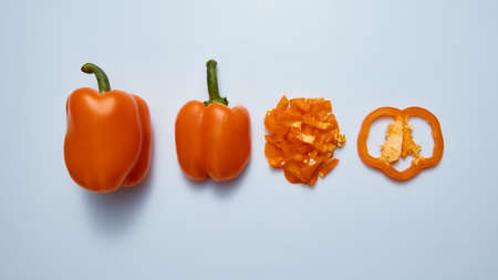 Fresh sweet bell peppers slices and half isolated on gray bacgkround